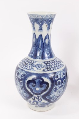 Lot 34 - Two similar 19th century Chinese blue and white bottle vases, both decorated with dragons, foliate patterns, ruyi symbols, etc, marks to bases, 22cm and 24.5cm high