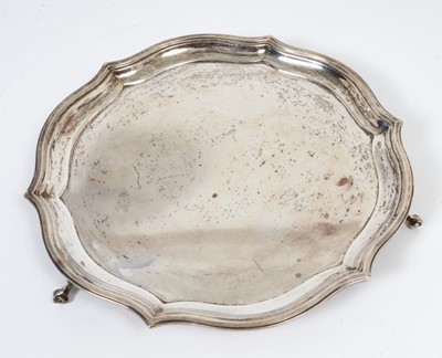 Lot 297 - George V silver salver of circular form with pie crust border, raised on three scroll feet, (Sheffield 1933), maker Roberts & Belk, all at 21ozs, 24.5cm in diameter.