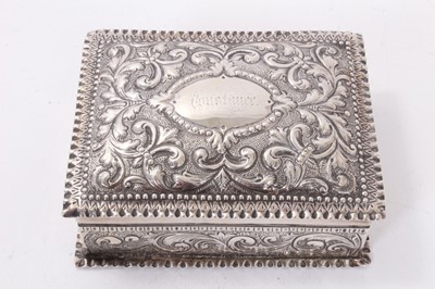 Lot 319 - Victorian silver dressing table box with repoussé floral scroll decoration (London 1884) 11.5 x 8.5 x 4 cm , Victorian silver smelling salts bottle and silver topped cut glass toilet jar (3)