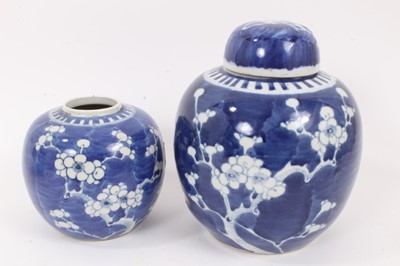 Lot 132 - A 19th century Chinese blue and white bowl and cover, together with two prunus jars, circa 1900 (one with cover)