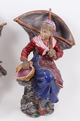 Lot 134 - A large pair of 19th century continental majolica wall pockets, in the form of a fisherman and his wife, impressed 'BU' mark to backs, 46cm high