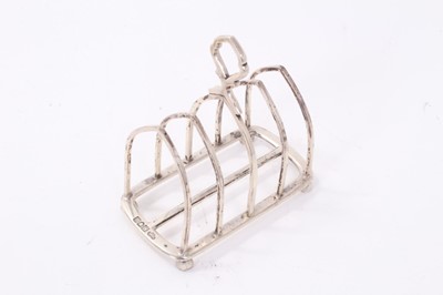 Lot 304 - Good quality Edwardian silver four division toast rack (London 1904), maker Goldsmiths & Silversmiths Company Ltd, together with two similar toast racks (Birmingham 1909) and (Sheffield 1935), all...