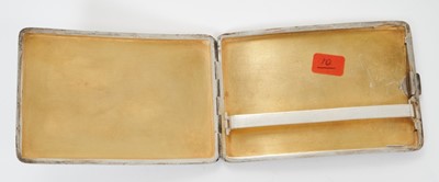 Lot 333 - Late 19th/early 20th century Chinese silver cigarette case of shaped rectangular form, with raised Dragon decoration and vacant to front and plain rear, silver gilt interior with Chinese character...
