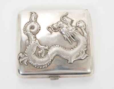 Lot 334 - Late 19th/early 20th century Chinese silver cigarette case of shaped form, with raised Dragon decoration and silver gilt interior, stamped WANG.FAI. All at approximately 3ozs. 8cm overall length.