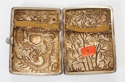 Lot 336 - Late 19th/early 20th century Chinese white metal cigarette case, the cover with raised Dragon decoration and engraved cartouche, the rear embossed with bamboo trees, silver gilt interior apparently...