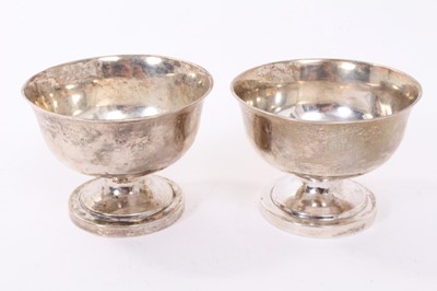 Lot 312 - Pair of Victorian silver salt cellars of cauldron form with gadrooned borders, raised on three scroll feet (London 1845 / 1848), maker George Ivory, together with a pair of 18th century white metal...