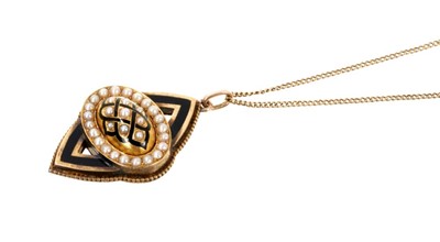 Lot 540 - Victorian gold, seed pearl and black enamel pendant on 15ct gold trace chain. The pendant 45mm x 28mm.