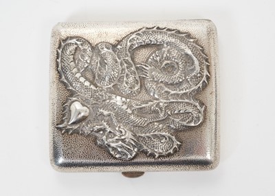 Lot 340 - Late 19th/early 20th century Chinese silver cigarette case of shaped form, with raised Dragon decoration against a spot hammered background and silver gilt interior stamped with Chinese character m...