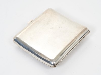 Lot 340 - Late 19th/early 20th century Chinese silver cigarette case of shaped form, with raised Dragon decoration against a spot hammered background and silver gilt interior stamped with Chinese character m...