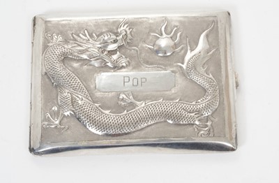Lot 344 - Late 19th/early 20th century Chinese silver cigarette case of rectangular form with a raised Dragon chasing the pearl and engraved POP, the rear engraved Mr H G Johnson, silver gilt interior stampe...