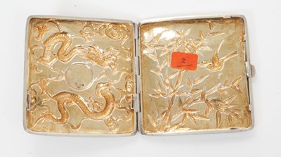 Lot 347 - Late 19th/early 20th century Chinese white metal cigarette case, the cover with raised Dragon decoration and engraved initials, the rear decorated with bamboo and a bird, silver gilt interior, appa...
