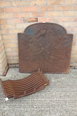 Lot 1376 - Antique cast iron fire back of arched form with figure and livestock decorated panel, together with a fire basket