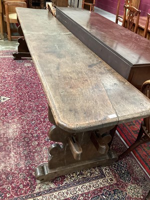 Lot 1370 - Highly unusual ecclesiastical oak refectory table/monks bench, probably 17th century, with massive single plank top raised on shaped trestle ends united by a substantial foot stretcher, 275 x 54cm