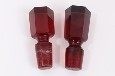 Lot 199 - A pair of Edwardian cranberry glass decanters with etched vine leaf decoration, 35.5cm high