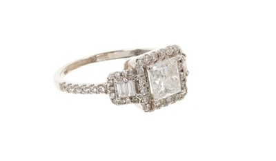 Lot 557 - Diamond ring with a central princess cut diamond weighing approximately 1.12cts, surrounded round brilliant cut diamonds flanked by baguette cut diamonds and further brilliant cut diamonds, estimat...