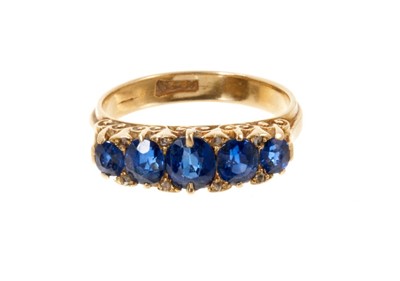 Lot 572 - Late Victorian sapphire five stone ring with five oval mixed cut blue sapphires with diamond accents to the claws in carved gold setting, on 18ct gold shank, M½.