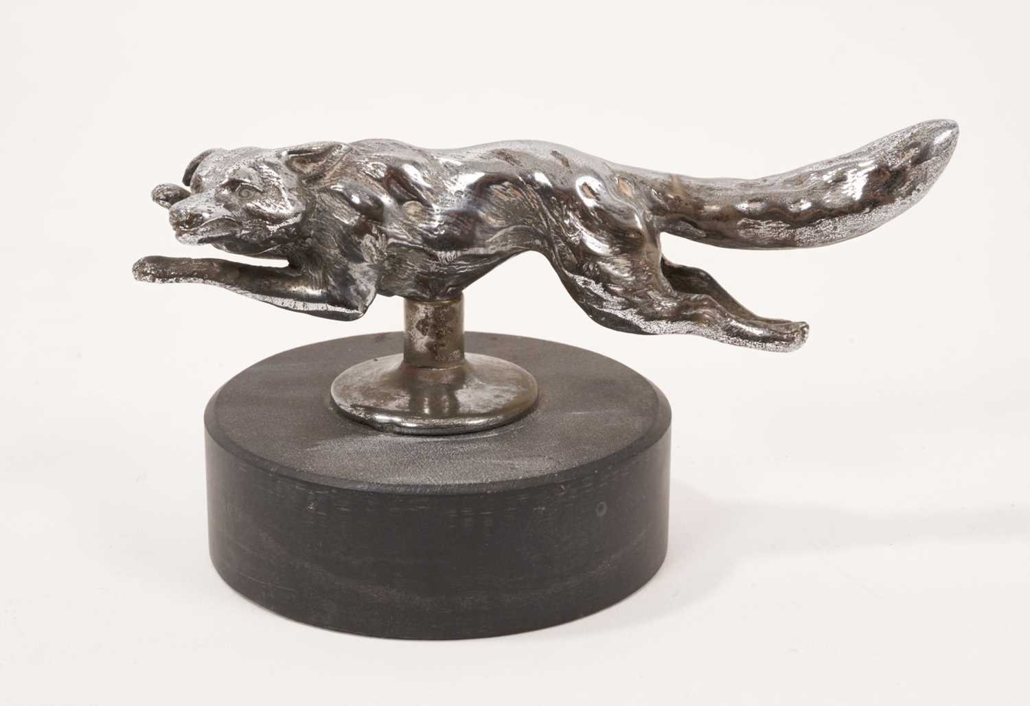 Lot 1119 - 1930s chrome plated running fox car mascot on slate plinth