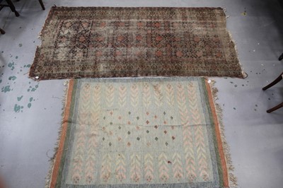 Lot 1426 - Antique Persian carpet, with allover foliate knotwork on midnight blue ground in multiple borders, 300 x 143cm, together with small modern woven rug, geometric ornament in muted tones, with tassel...