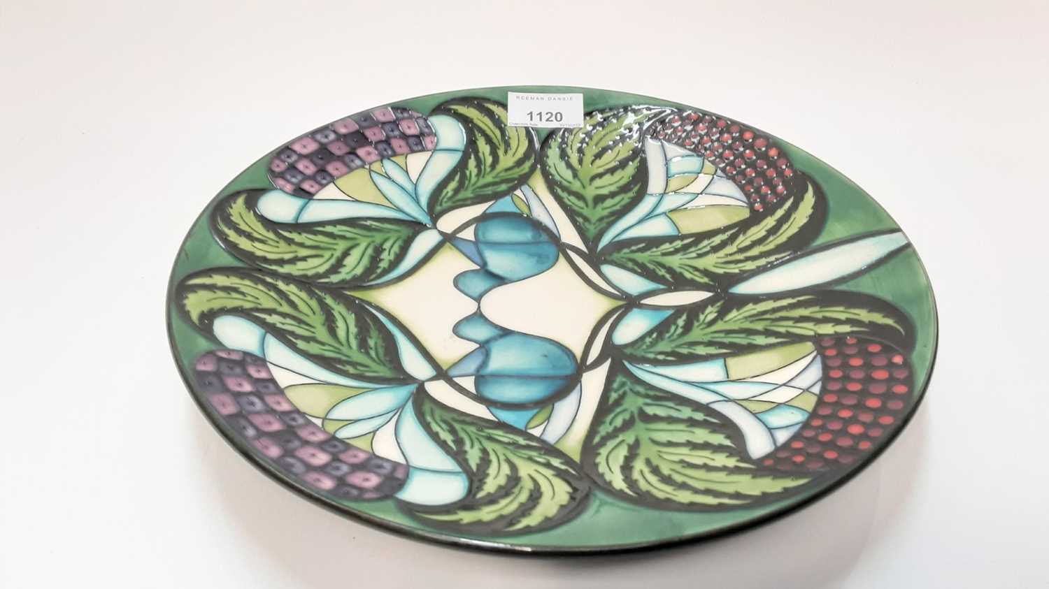 Lot 1156 - Moorcroft pottery circular charger decorated in the Blackwell by Nicola Slaney, dated 2008, 28cm diameter