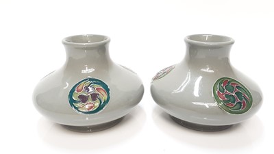 Lot 1153 - Pair of Moorcroft pottery squat vases each with three circular motifs on grey ground, 8cm high