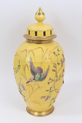Lot 210 - Continental yellow ground vase with raised polychrome painted bird and flower decoration. Sunburst 584 mark on underside