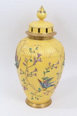 Lot 187 - Continental yellow ground vase with raised polychrome painted bird and flower decoration. Sunburst 584 mark on underside