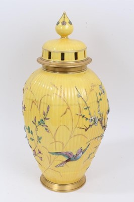 Lot 210 - Continental yellow ground vase with raised polychrome painted bird and flower decoration. Sunburst 584 mark on underside