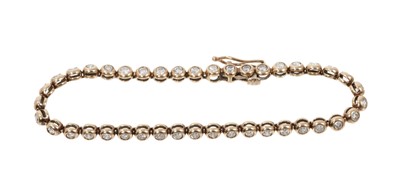 Lot 789 - Diamond tennis bracelet with a line of round brilliant cut diamonds in 9ct yellow gold setting, estimated total diamond weight approximately 2cts.