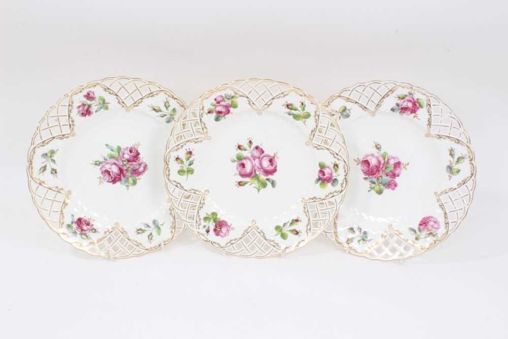 Lot 237 - Set of three Minton plates with pierced borders and polychrome painted with floral sprays