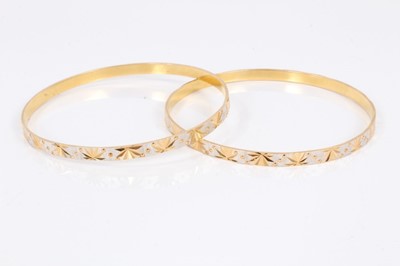 Lot 746 - Two Indian yellow metal bangles with diamond cut decoration