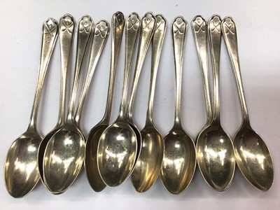 Lot 1073 - Set of twelve silver golf related teaspoons