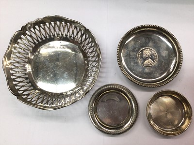 Lot 1075 - Silver bowl with pierced decoration, silver coin dish set with one rupee and two other silver pin dishes (4)