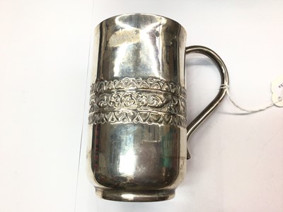 Lot 1076 - White metal tankard with embossed decoration, stamped 'silver' to base