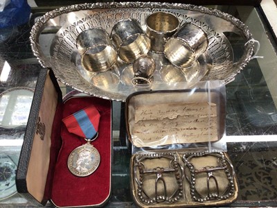 Lot 435 - Pair of antique shoes buckles in original fitted case, Faithful Service medal, four silver plated napkin rings, white metal pepperette and plated oval dish with pierced decoration