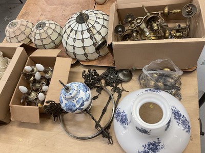 Lot 600 - Group of light fittings to include three Tiffany style leaded glass ceiling lights, hanging oil lamp-style light, 1920s anodised copper finish standard lamp, brass wall lights together with antique...