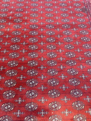 Lot 1410 - Large rug on red ground