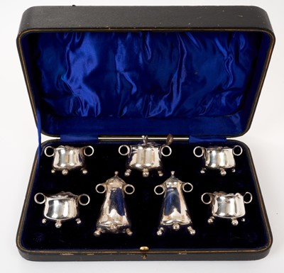 Lot 418 - George V seven piece silver condiment set in fitted case
