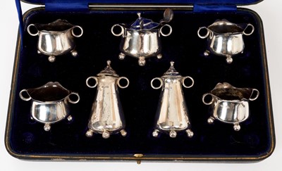 Lot 418 - George V seven piece silver condiment set in fitted case