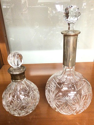 Lot 1104 - Silver mounted cut glass spirit decanter and a silver mounted (800 standard) cut glass decanter