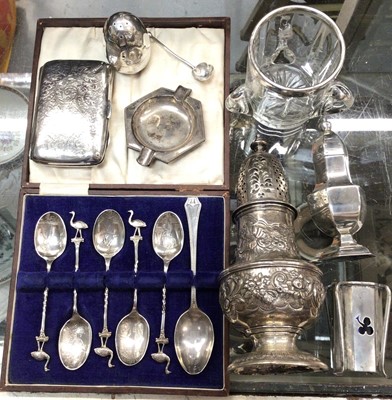 Lot 1093 - Group of silver to include Georgian sugar caster, cigarette case, condiments, ashtray, spoons and silver mounted glass tyg