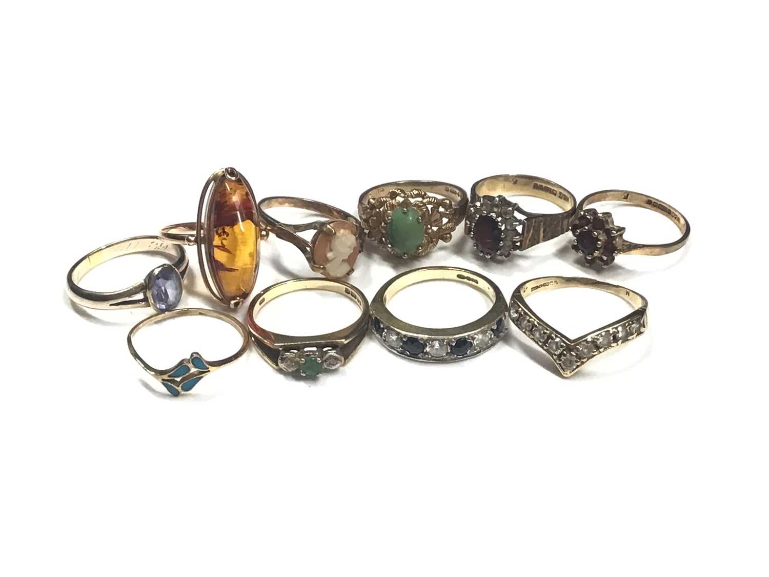 Lot 9 - Seven 9ct gold gem set dress rings, gold (583) amber ring, gold (333) blue stone ring and a yellow metal enamelled ring (10)