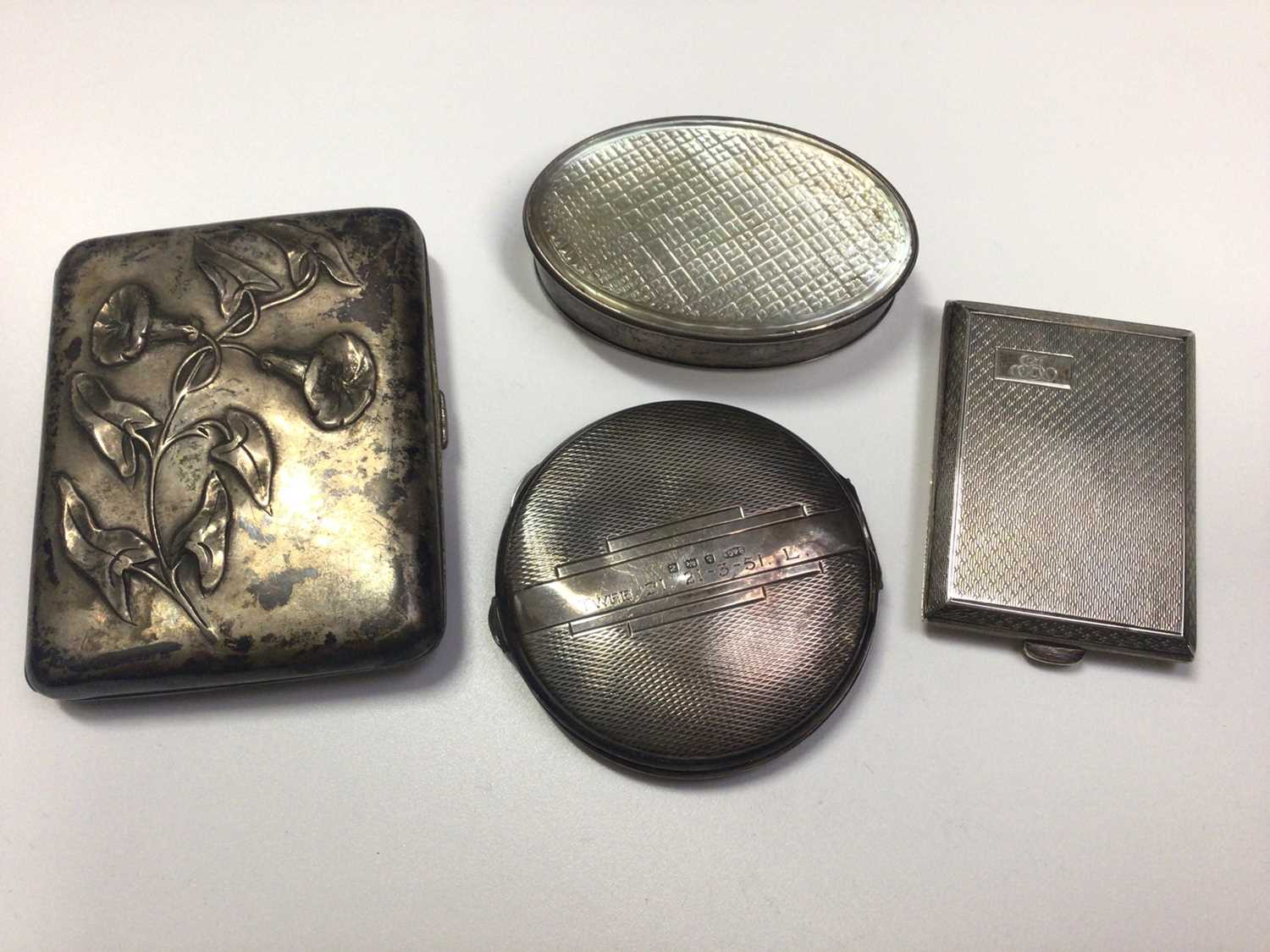 Lot 12 - French silver cigarette case with embossed floral decoration, small silver card case, silver powder compact and white metal oval trinket box with mother of pearl cover