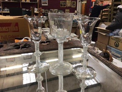 Lot 111 - Pair of antique wine glasses with opaque air twist stems and a Georgian wine glass with bucket shape bowl and air twist stem on folded foot (3)