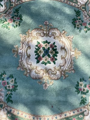 Lot 1397 - Circular wool rug on green ground