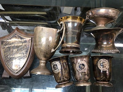 Lot 1064 - Silver two handled trophy, silver mounted wooden shield plaque and group of white metal presentation cups