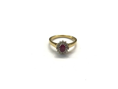 Lot 1032 - 18ct gold ruby and diamond cluster ring