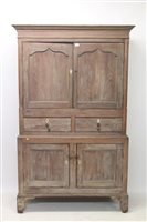 Lot 1104 - George III limed oak livery cupboard with...