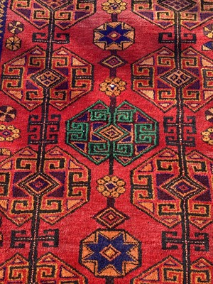 Lot 1279 - Eastern rug with geometric decoration on red, blue and orange ground, 204cm x 163cm