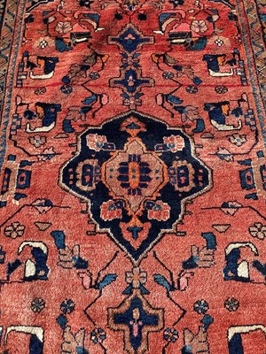 Lot 1280 - Eastern rug with geometric decoration on red and blue ground, 282cm x 160cm