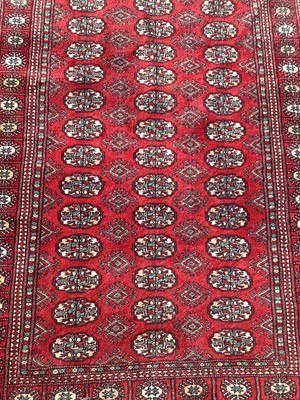 Lot 1300 - Eastern rug with geometric decoration on red ground, 185cm x 119cm